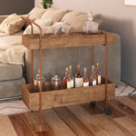 Industrial style bar cart made from wood and coppery steel legs with 2 shelves and 2 wheels